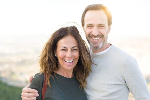 Man and woman smiling with dental implants in Shrewsbury PA
